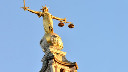 Image of a statue of Justice, holding scales