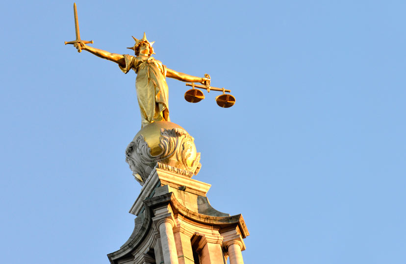 Image of a statue of Justice, holding scales